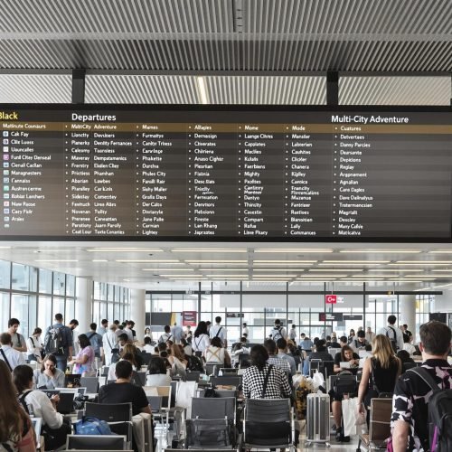 Travelers in airport lounge planning multi-city adventure